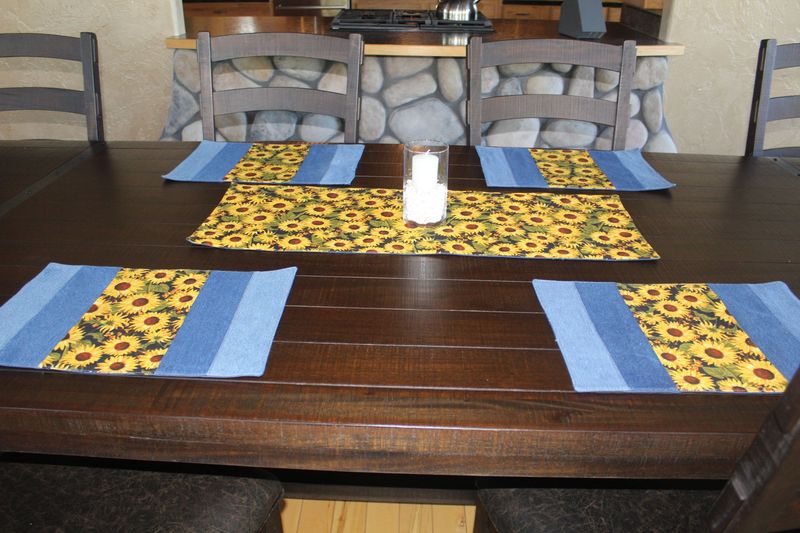 Handmade sunflower table runner and placemats set on wooden dining table 