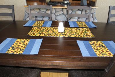 Handmade sunflower table runner and placemats set on wooden dining table 