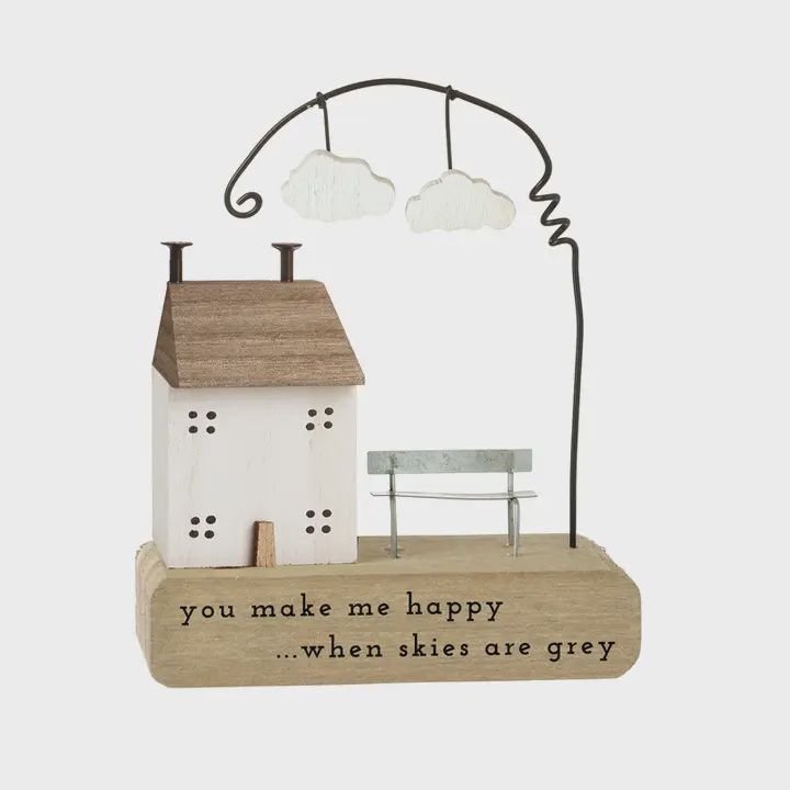 Wooden House on block with Clouds