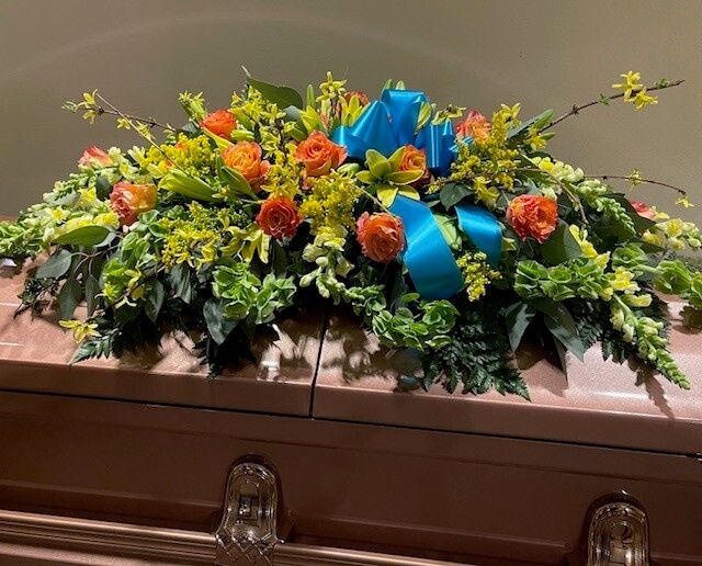 Rose casket piece with ribbon accent