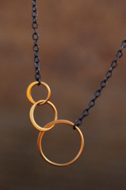 Three gold vermeil rings on oxidized silver chain with 2" 14kt gold-filled chain drop