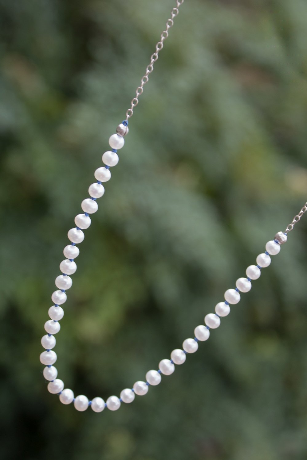 String of pearls on silk cord with sterling chain & clasp