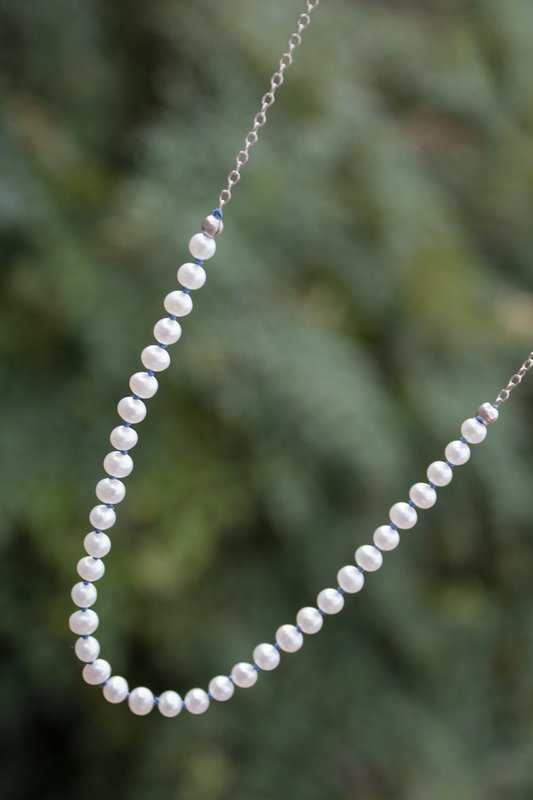 String of pearls on silk cord with sterling chain & clasp