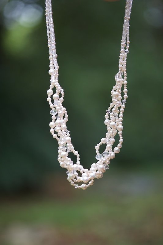 6 strands of large and small pearls, Swarovski crystal accents, sterling silver clasp