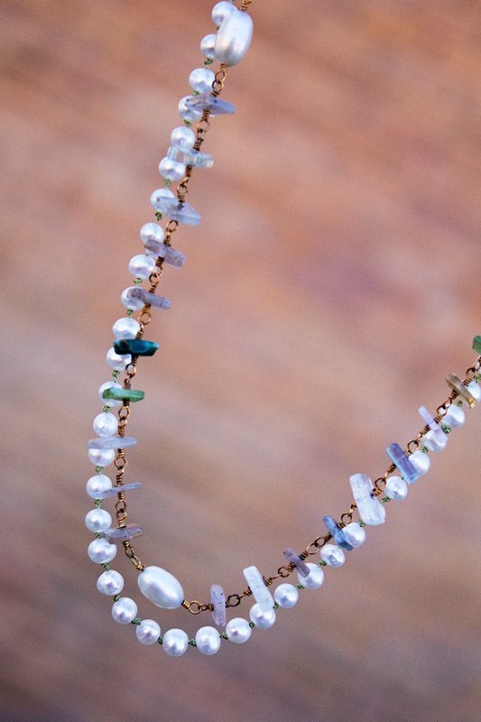 Strand of pearls on silk cord and strand of quartz beads on gold wire