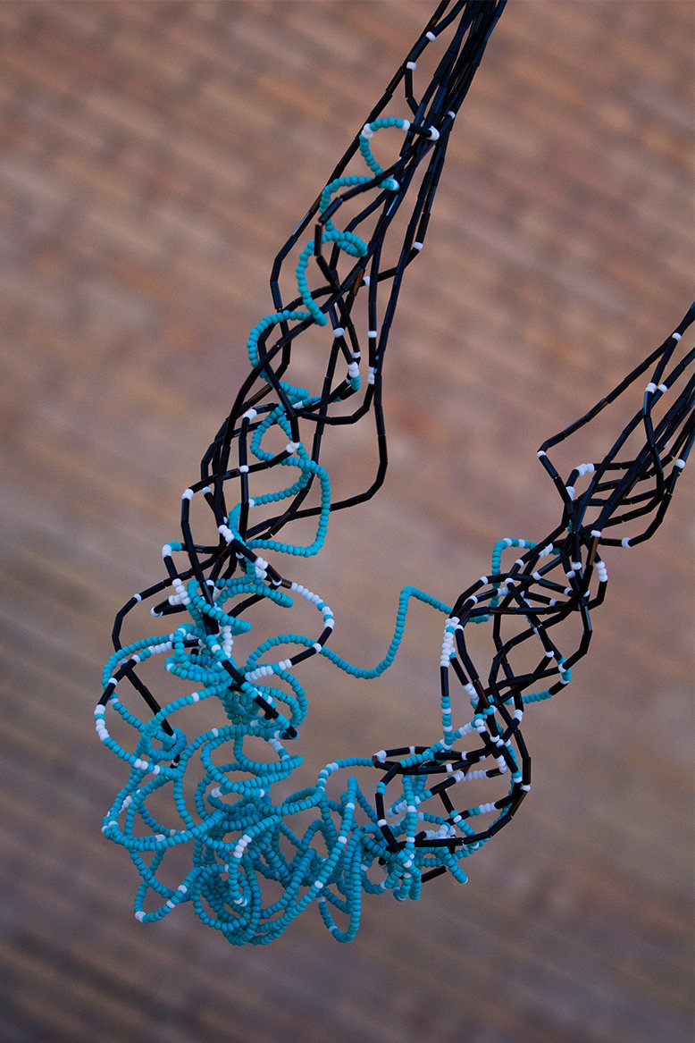 Multiple strands of turquoise-color, black and white seed beads on curly wire, sterling findings