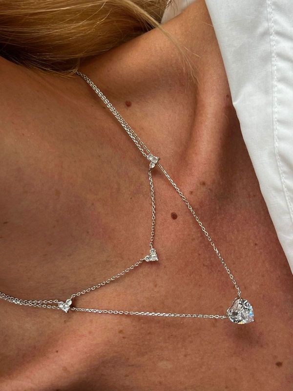 “Double Necklace” has a white crystal zirconia stone with heart format , and receive plating white gold