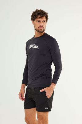 Man wearing Johnn Brava black lycra UV protection shirt while surfing
