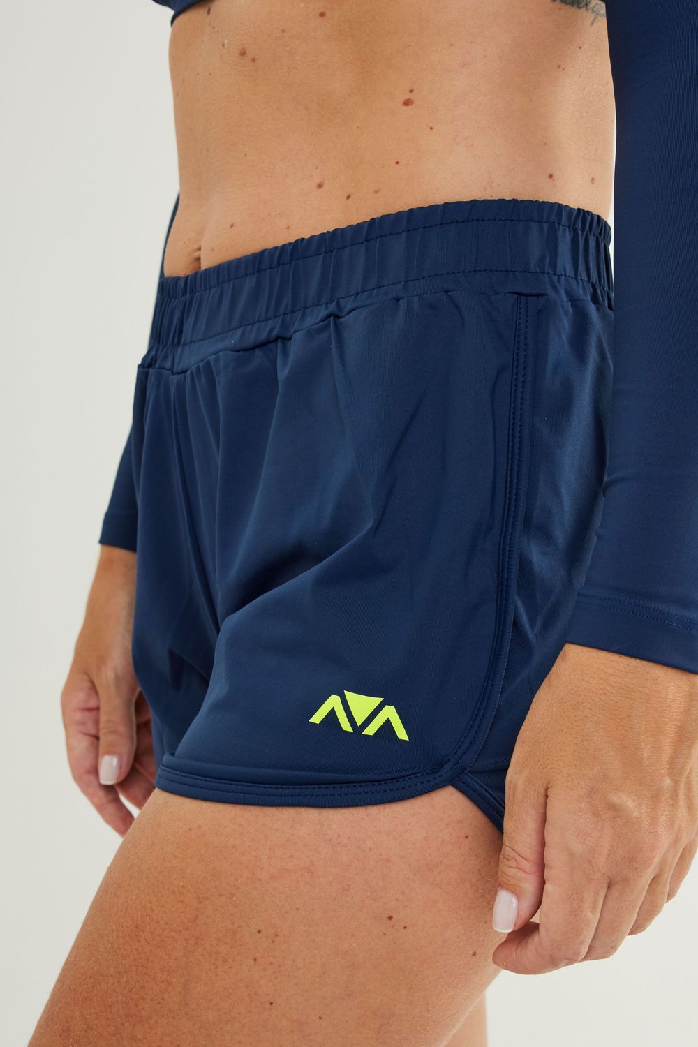 Man wearing Johnn Brava blue JetFit shorts on the beach