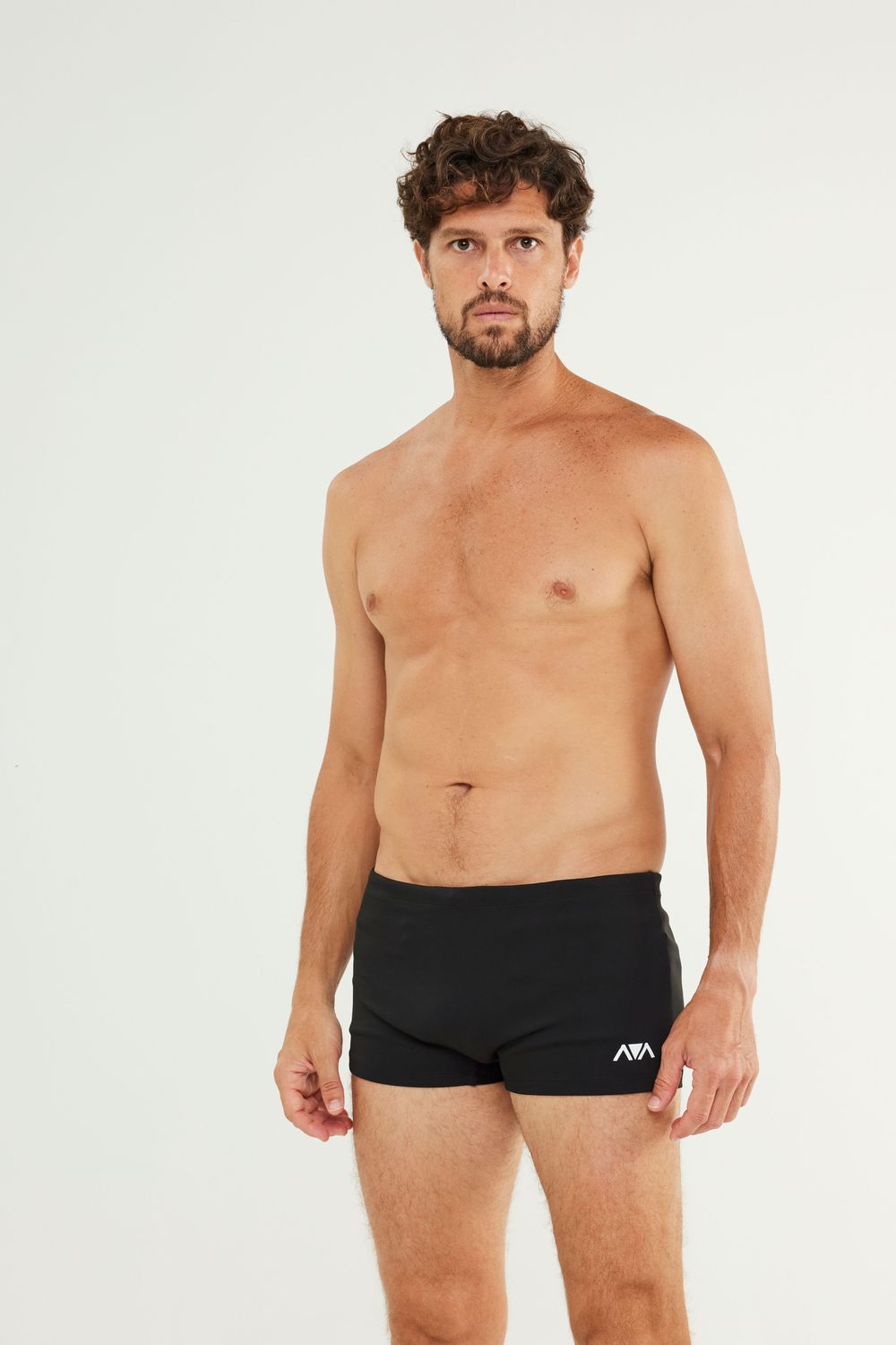 Man wearing Johnn Brava neo slim swim trunks at the beach - view 2