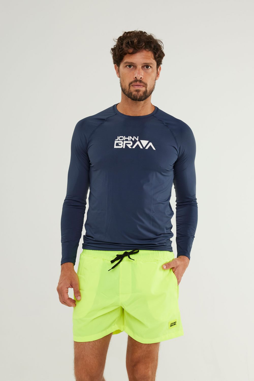 Man wearing Johnn Brava blue lycra UV protection shirt while surfing
