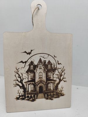Personalised laser engraved Halloween wooden sign with haunted house and bats design, natural wood with jute twine hanger
