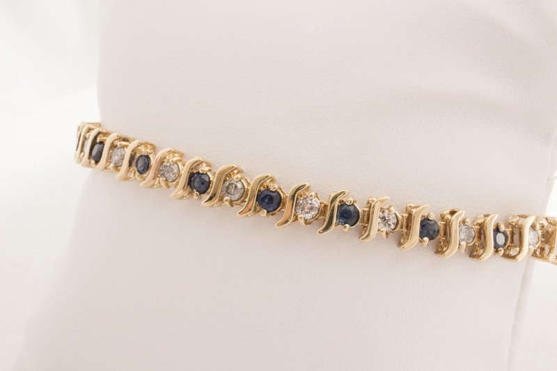 10 Karat Yellow Gold Sapphire And Round Diamond. 10 Karat Yellow Gold Sapphire And Round Diamond.