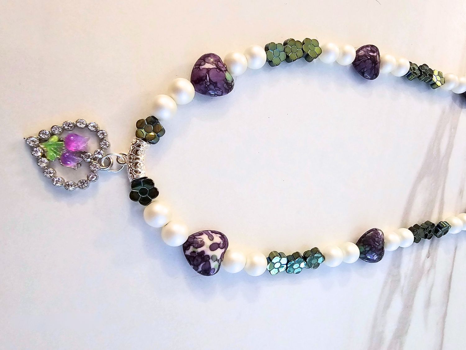 Purple heart turquoise, green flower hematite, pearls with a heart charm and purple flowers