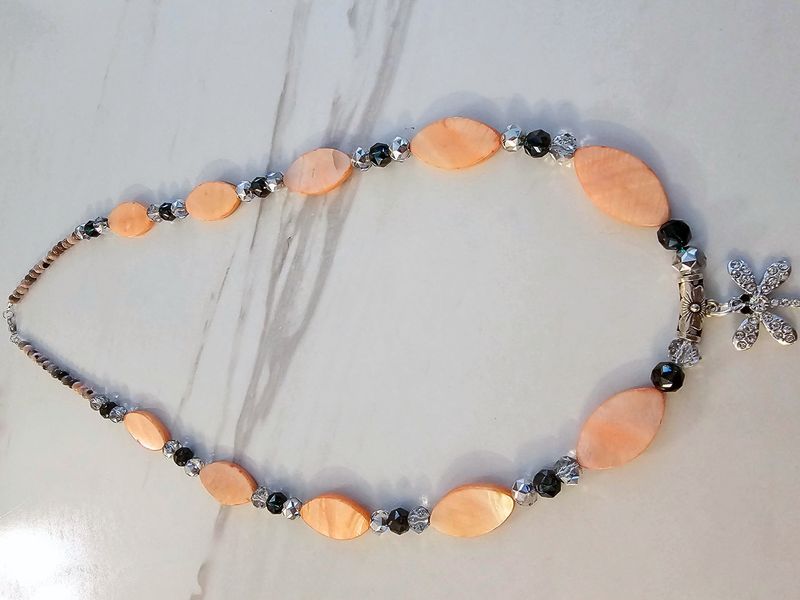 Orange shell with silver and black crystal beads, firefly charm