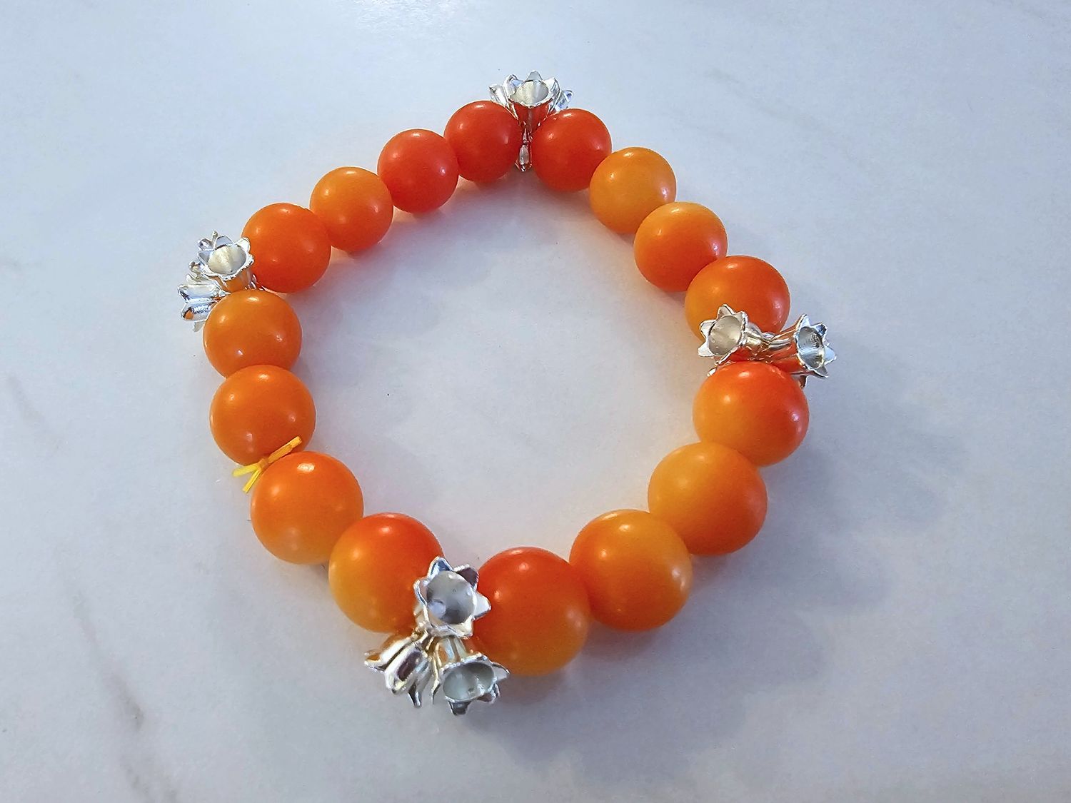 Orange bodhi beads with silver flower charms