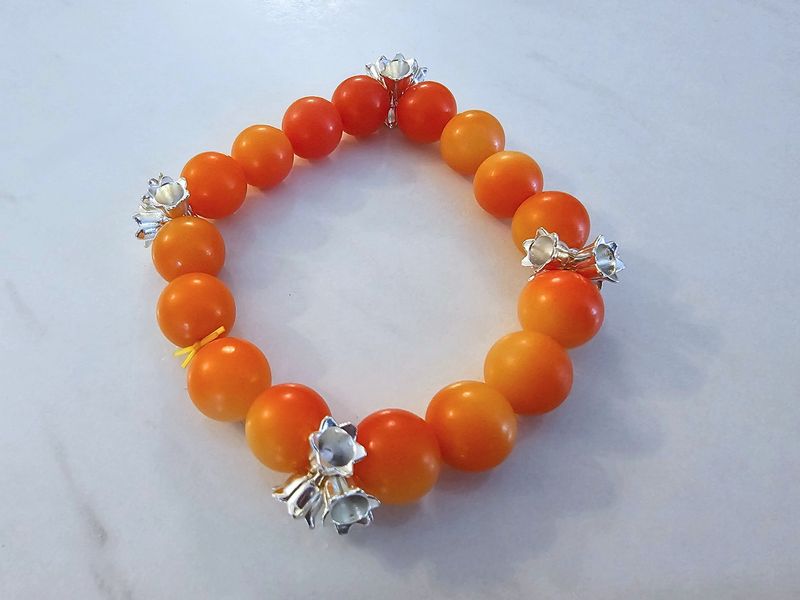 Orange bodhi beads with silver flower charms