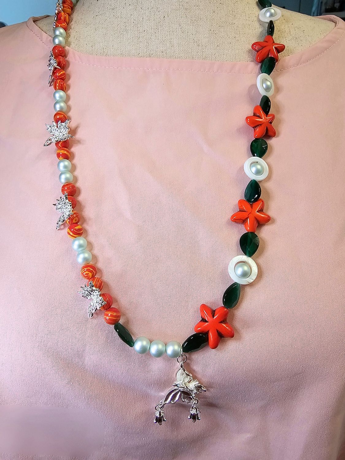 Two tone orange flowers with butterflies, pearls and green cat eyes