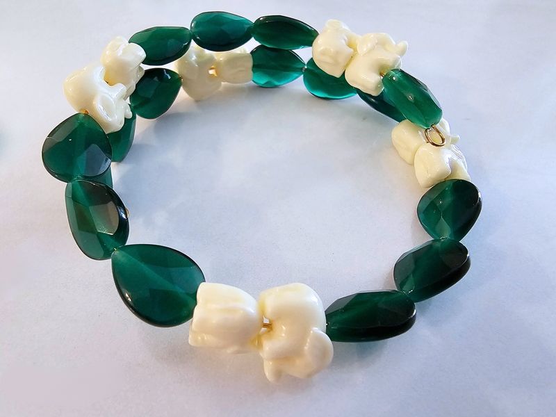 Green cat eyes with cream elephant turquoise on memory wire.