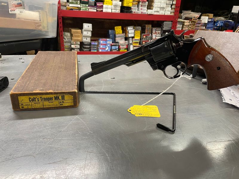 Colt Trooper MK III, 357 Magnum, Blued, checkered stocks/silver medallions. 2nd year production 1970, with original box. Very Good condition, slight loss of bluing between two cylinder flutes Colt Trooper MK III, 357 Magnum, Blued, checkered stocks/silver medallions. 2nd year production 1970, with original box. Very Good condition, slight loss of bluing between two cylinder flutes