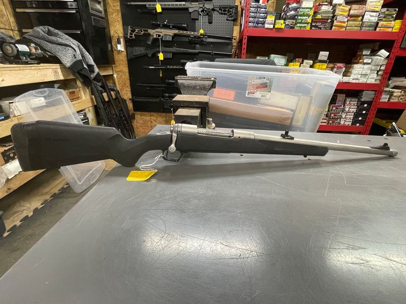 Savage Model 110, Stainless, 338 Winchester Magnum. Right hand bolt, 20 inch threaded barrel. Iron sights. Unfired , has minor storage scratches