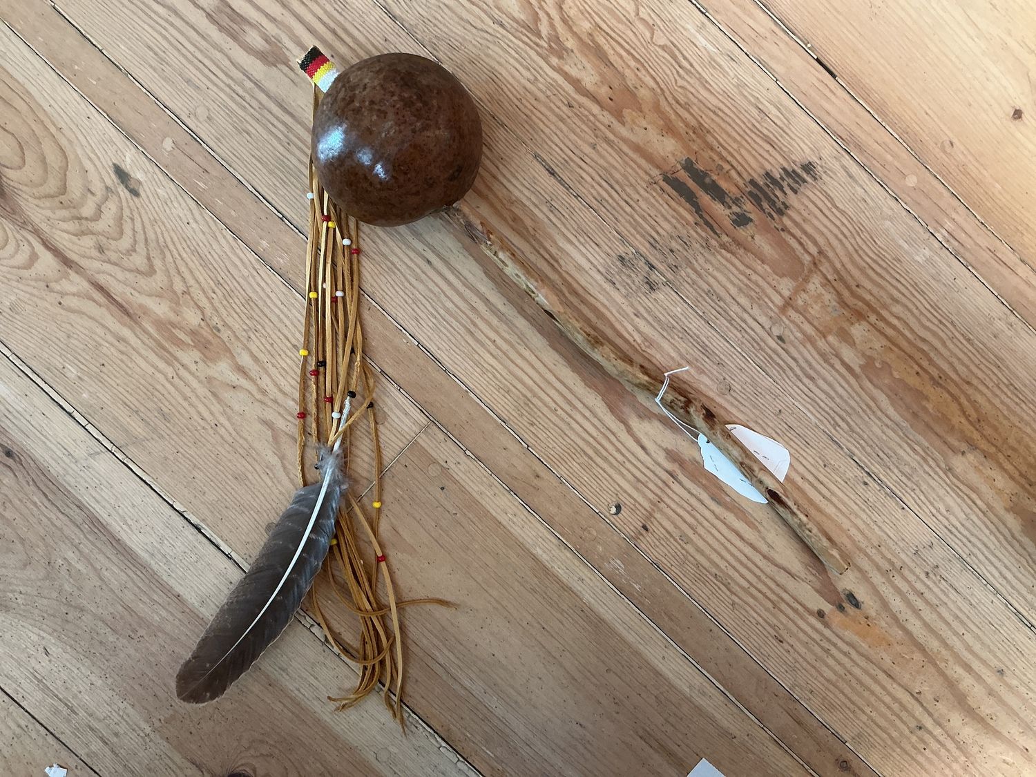 Wood Rattle with Feather Long