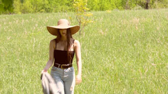 Girl with hat walking in field -20 CV32P