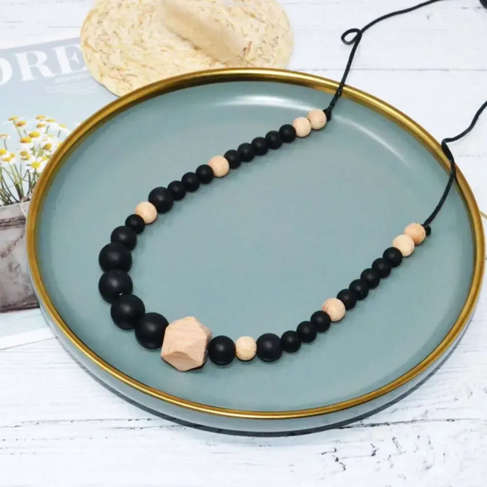 Collier d'allaitement ou de portage noir silicone + bois - Irréversible Bijoux