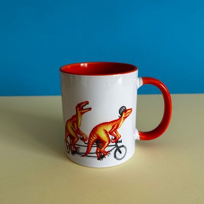 Tasse Velociraptor en vélo