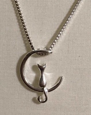 Kitty on a New Moon Necklace.