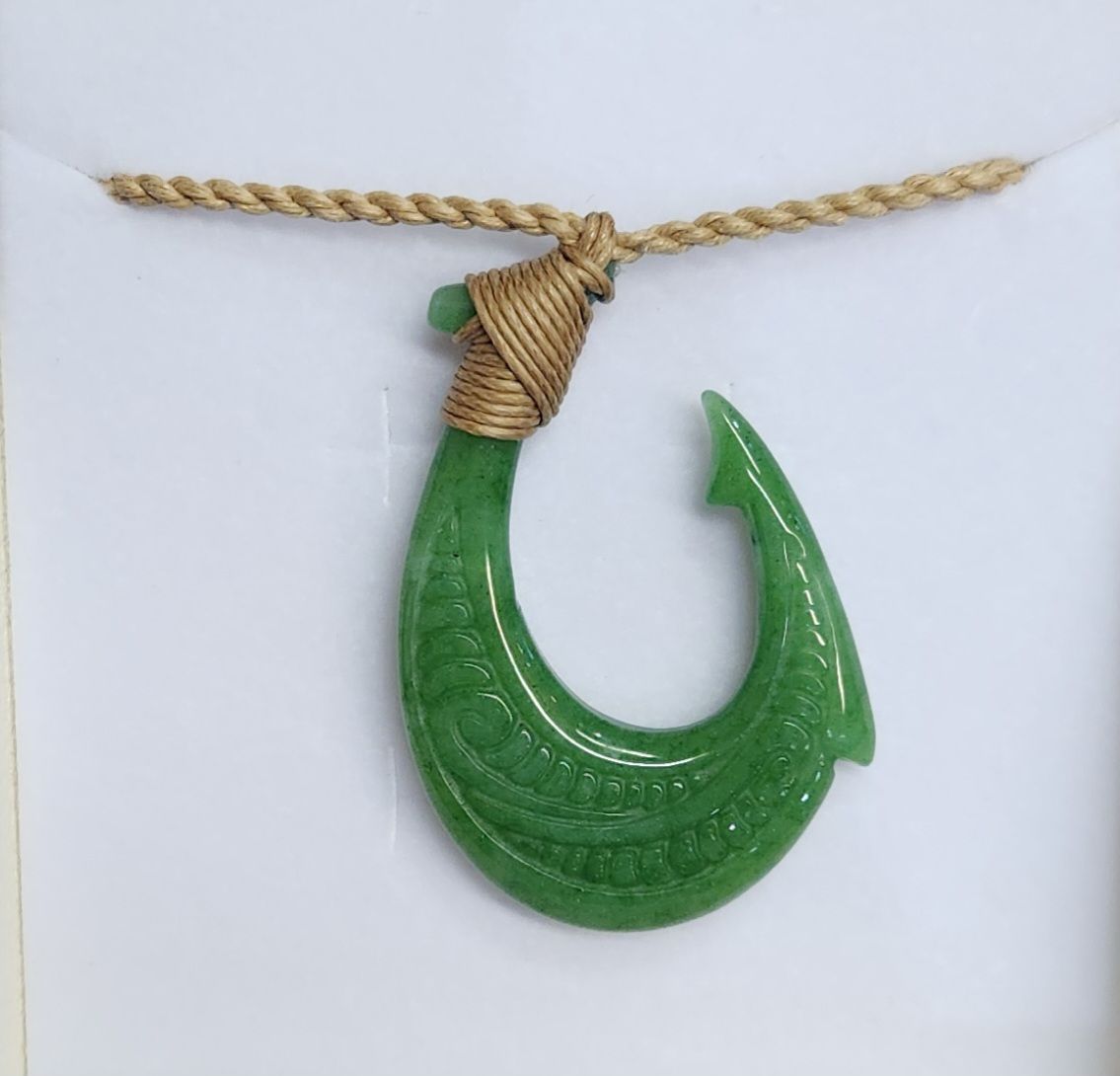 Fish Hook Carved in Bone with Tatoo Design, material: Carved Green Jade on Natural Hemp Cord