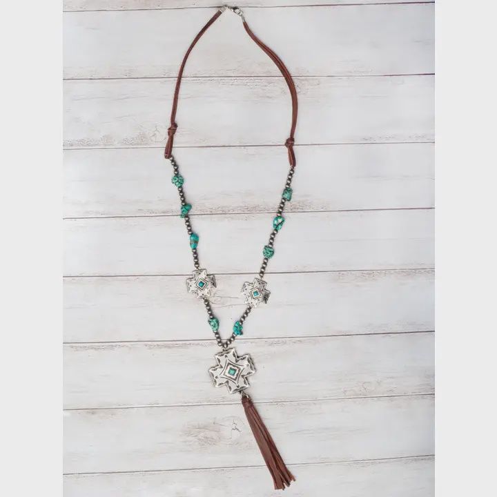 Boots, Jeans, Turquoise Silver Cross Concho with Brown Leather Tassel On A Navajo Pearl Necklace