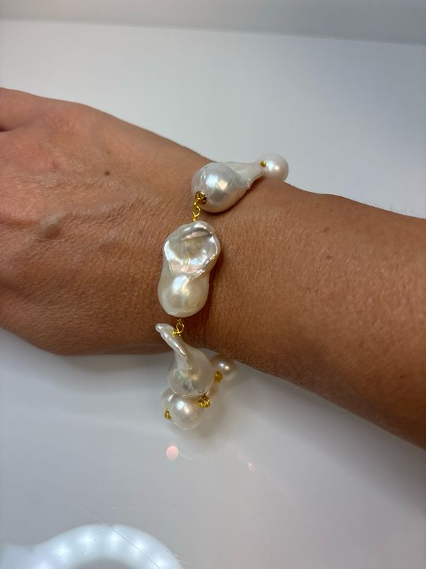 Bracciale con perle di coltivazione di acqua dolce e scaramazze  con elementi in argento 925 placcati oro.