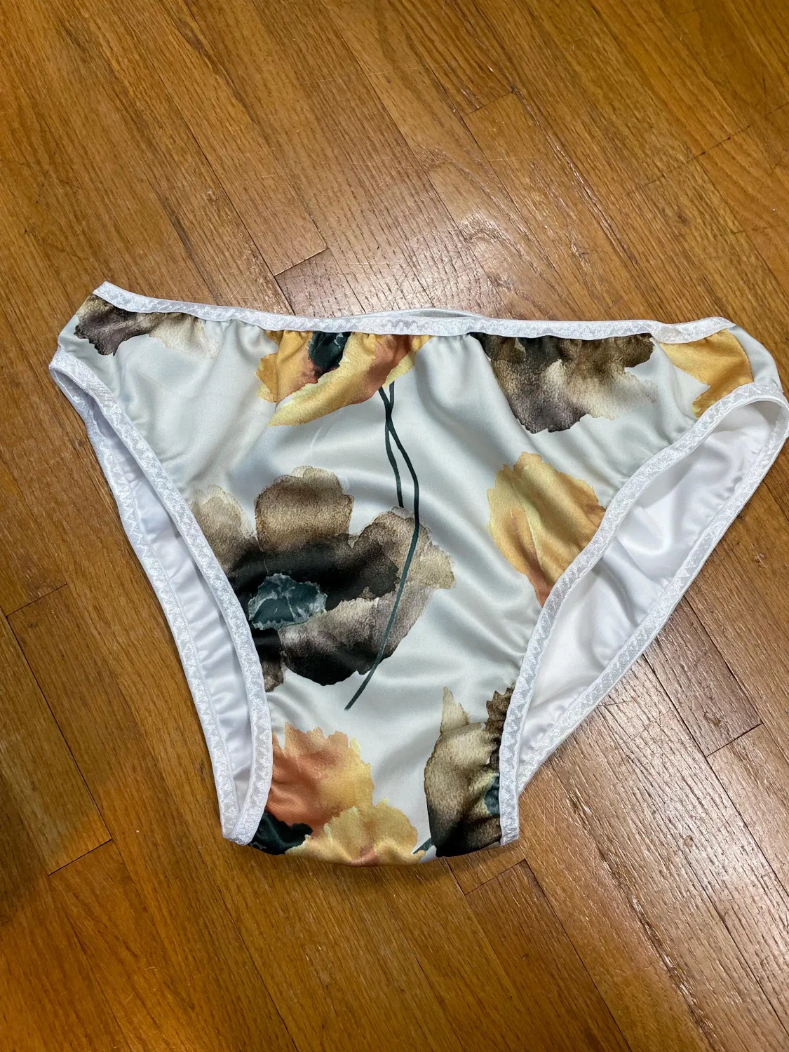French Cut High Leg, Brown Floral Satin Prints /White Satin backing. Reversible with white trim. Size 40-43&quot; waist.