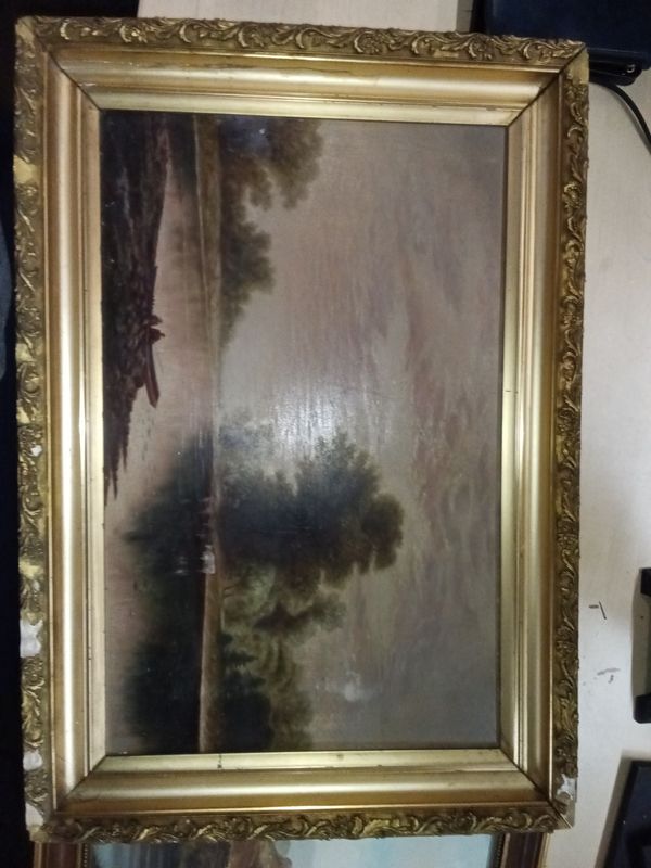 19th-century oil on canvas landscape painting featuring a waterway and tree scene.It is housed in an ornate gold-gilt wooden frame that shows signs of minor damage, such as missing pieces.