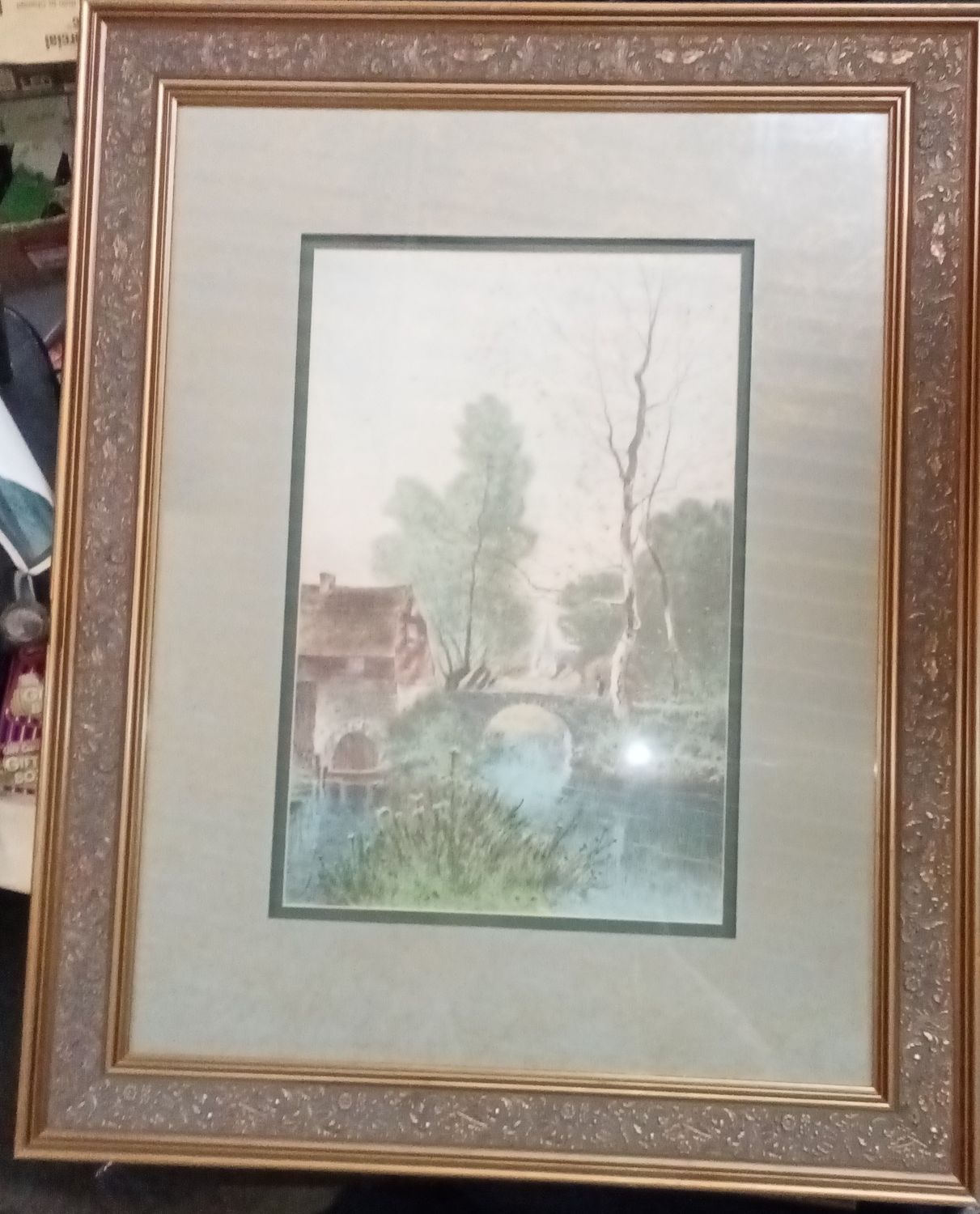 This framed artwork appears to be a hand-colored aquatint etching by artist Marcel Augis, depicting a French country scene with a stone bridge.