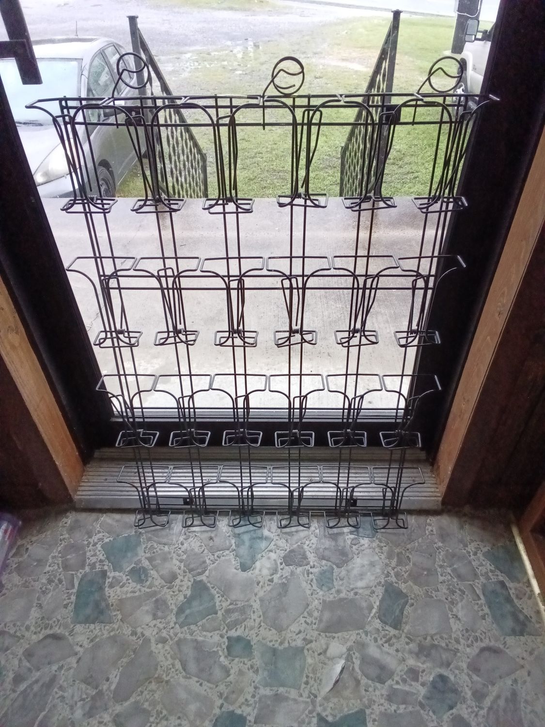 black wire metal rack24 pockets, making it suitable for organizing pamphlets or brochures in retail or office settings