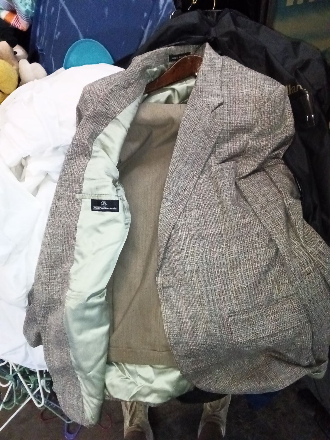 Jean Paul Germain blazer features a textured, light gray weave and a light blue inner lining