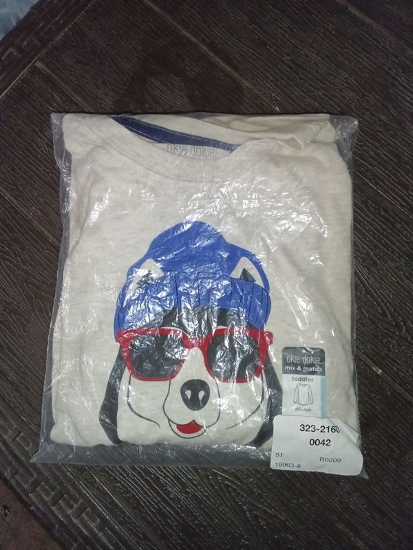 OshKosh B'gosh toddler t-shirt features a playful graphic of a dog wearing sunglasses and a blue beanie.