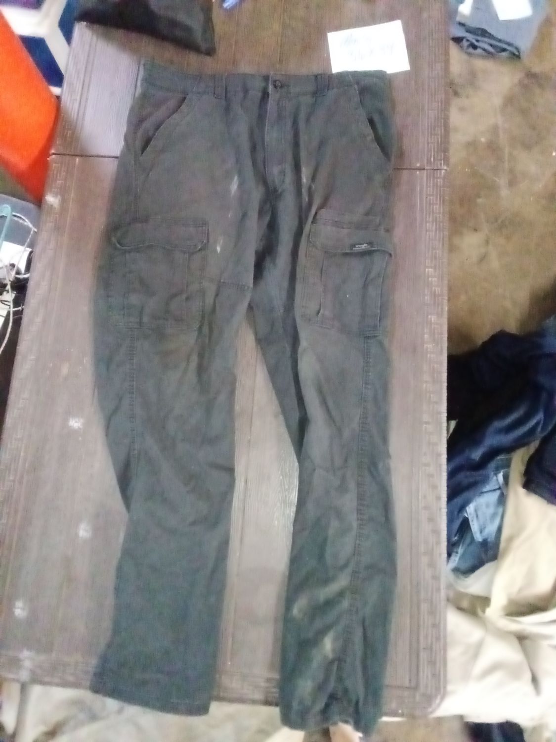 Wrangler men's black utility cargo jeans feature a side pocket and a tag indicating they were made in Nicaragua. Size 36x34