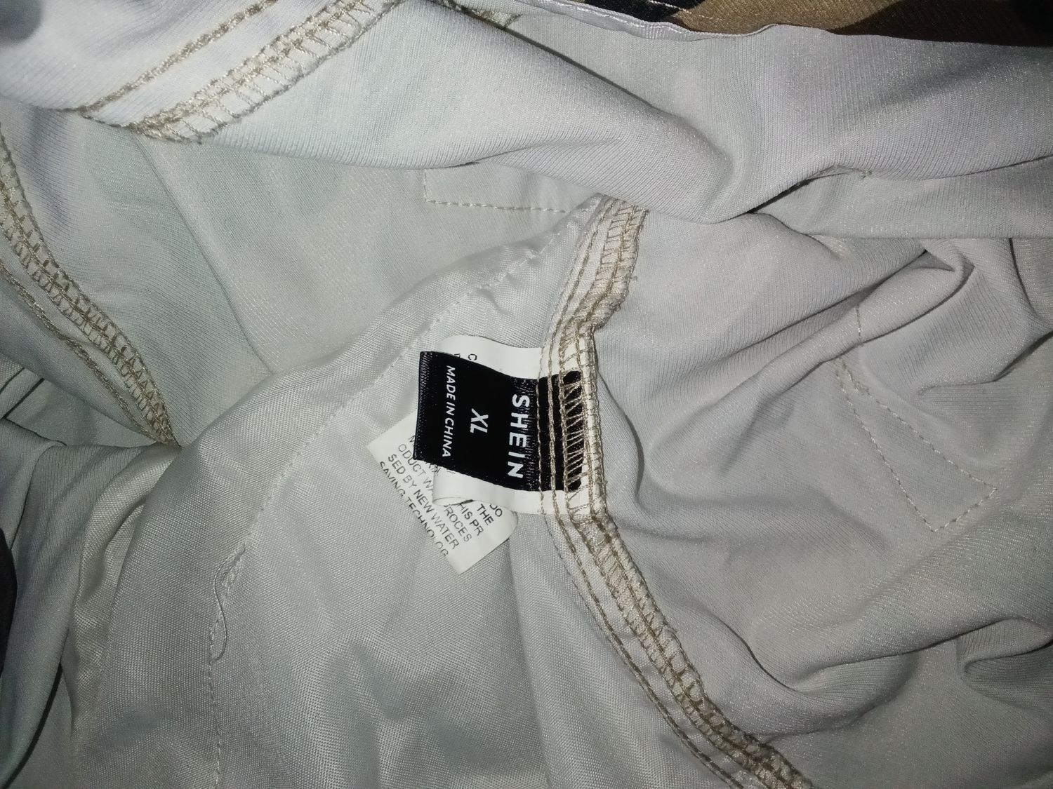 Pants are from SHEIN, featuring a camouflage pattern and a size XL label. Size XL