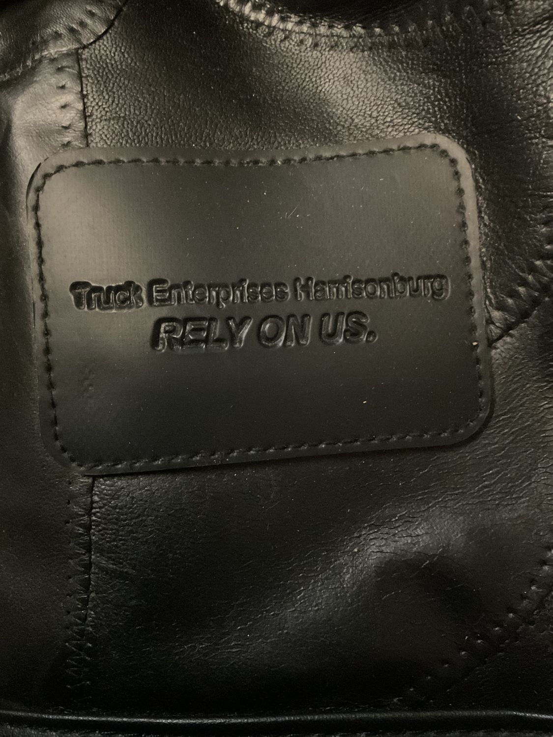 Custom embossed pieced patchwork black leather (or faux leather) rolling duffle bag