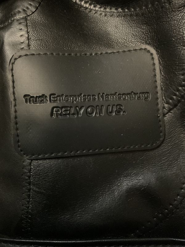 Custom embossed pieced patchwork black leather (or faux leather) rolling duffle bag