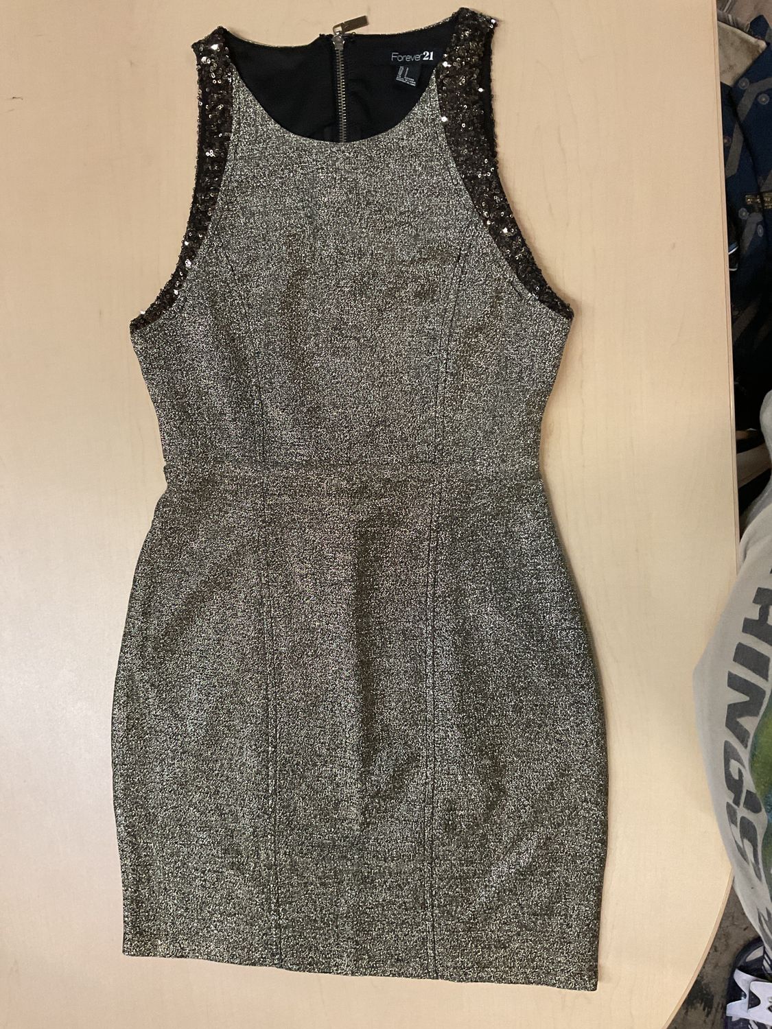 Forever 21 Metallic Gold and Black Glitter Cocktail Dress featuring a structured bodycon silhouette, a high sleeveless neckline, and sequined trim along the armholes. It is designed with a full-length