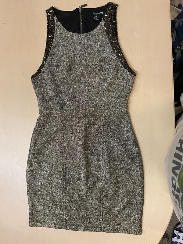 Forever 21 Metallic Gold and Black Glitter Cocktail Dress featuring a structured bodycon silhouette, a high sleeveless neckline, and sequined trim along the armholes. It is designed with a full-length