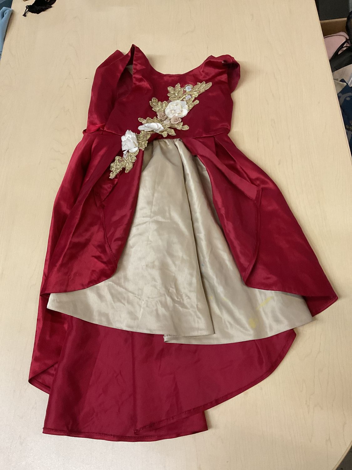 wine red and champagne high-low flower girl princess dress featuring an asymmetrical skirt and elegant gold floral embroidered appliqués along the front. Size unknown.