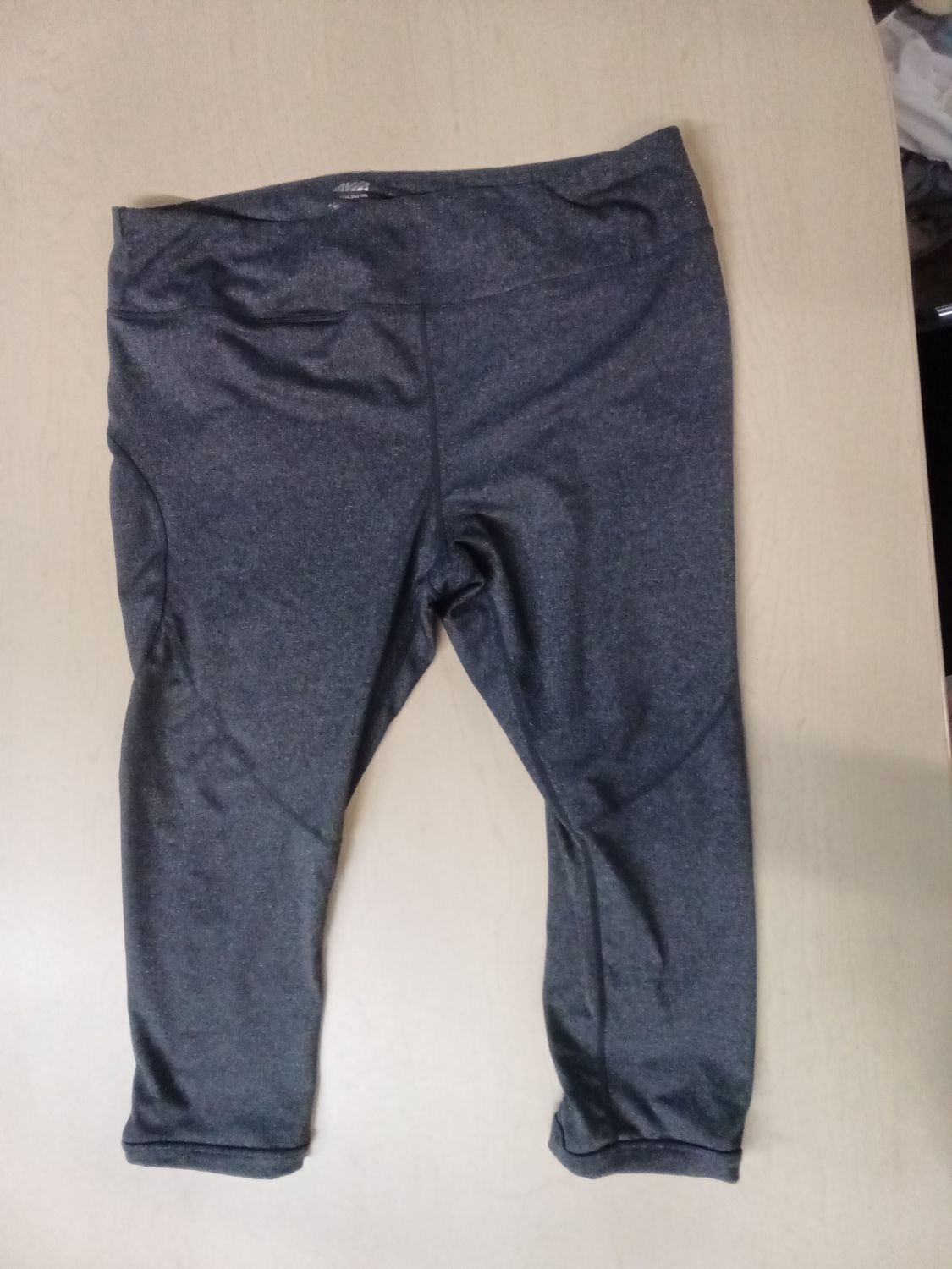 Dark gray Avia cropped capri leggings featuring a unique side-ruched lattice detail on the lower legs size 3X