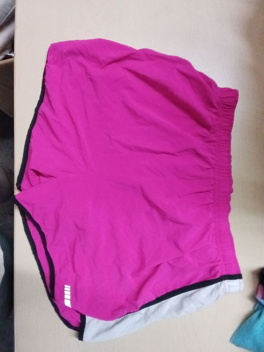 pink BCG Tru-Wick athletic shorts featuring a lightweight, moisture-wicking performance fabric and an elastic waistband.size L