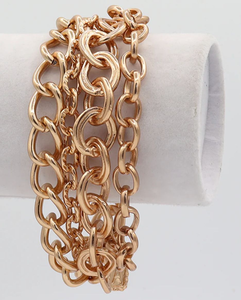Multi layer bracelet featuring four rows of mixed chains.