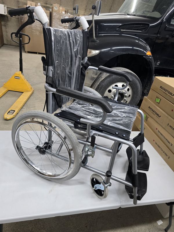 Wheelchair with standing-assist brakes